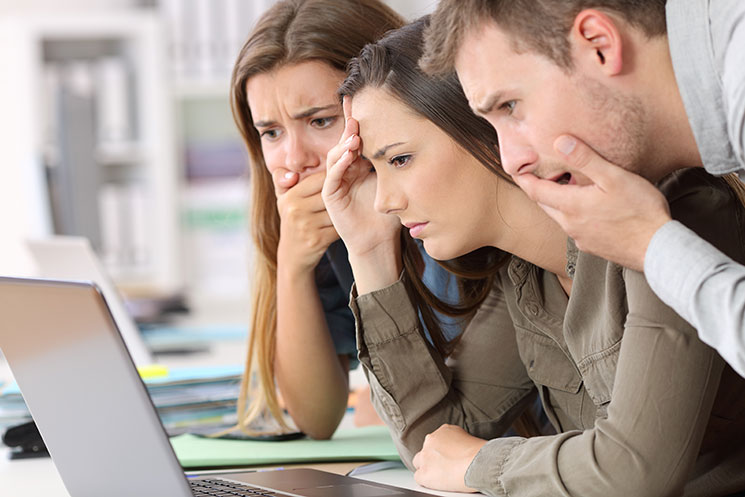 people staring at a computer screen puzzled